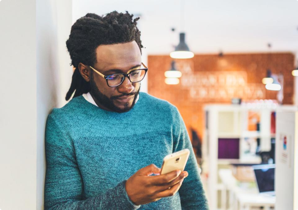 Man scrolling through his smartphone image