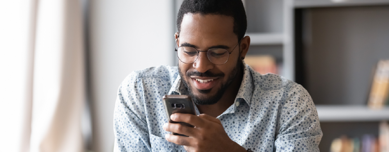 <A man reading surprising cross-border payment statistics on his mobile device