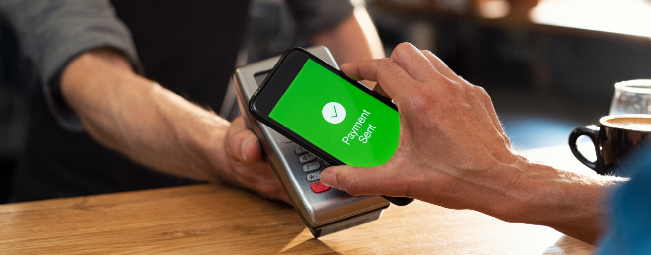 A consumer paying with a mobile wallet at the point of sale